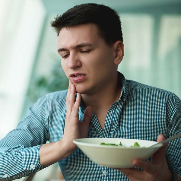 Man in pain while eating
